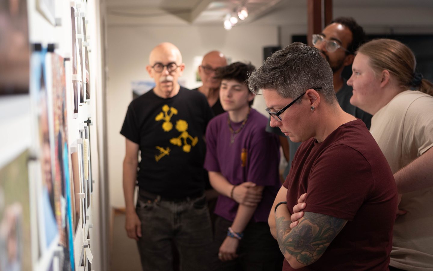 Participants examining photographic work on display during a photography and new media workshop at Anderson Ranch Arts Center.
