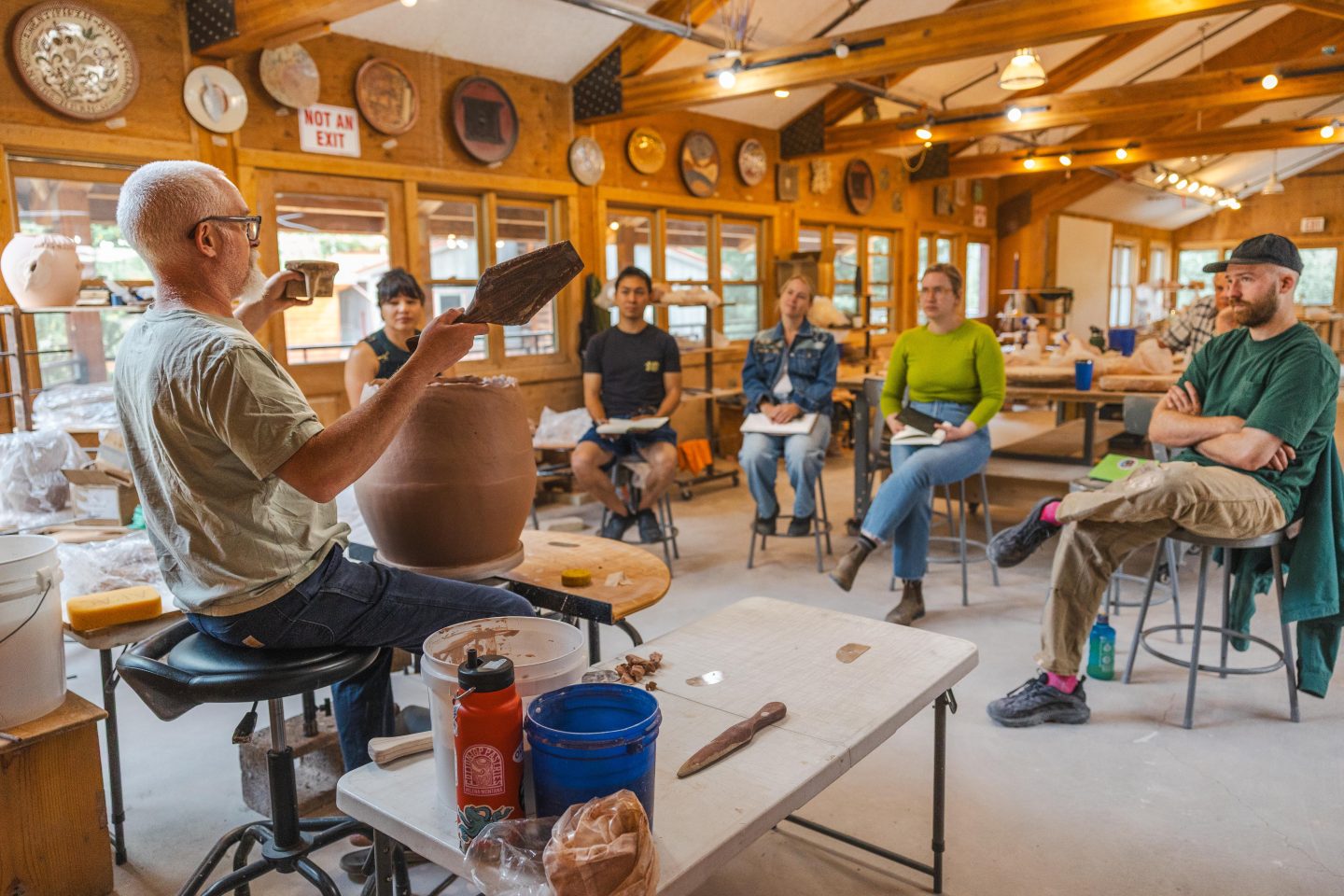 wheel throwing ceramics workshop in a professional studio setting