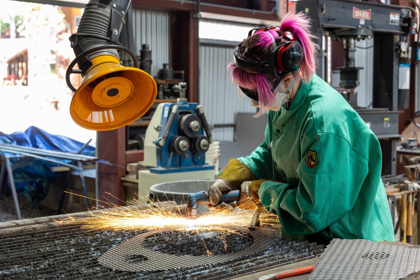 sculptor using tools to shape metal in a studio workshop at Anderson Ranch Arts Center