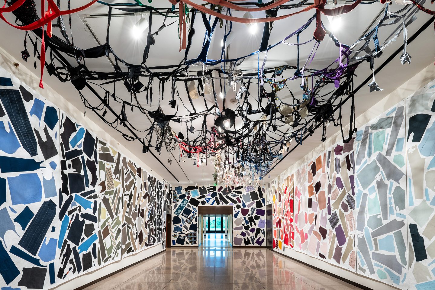 installation artwork composed of cut fabric, thread, adhesive, and Tyvek forming a suspended sculptural structure