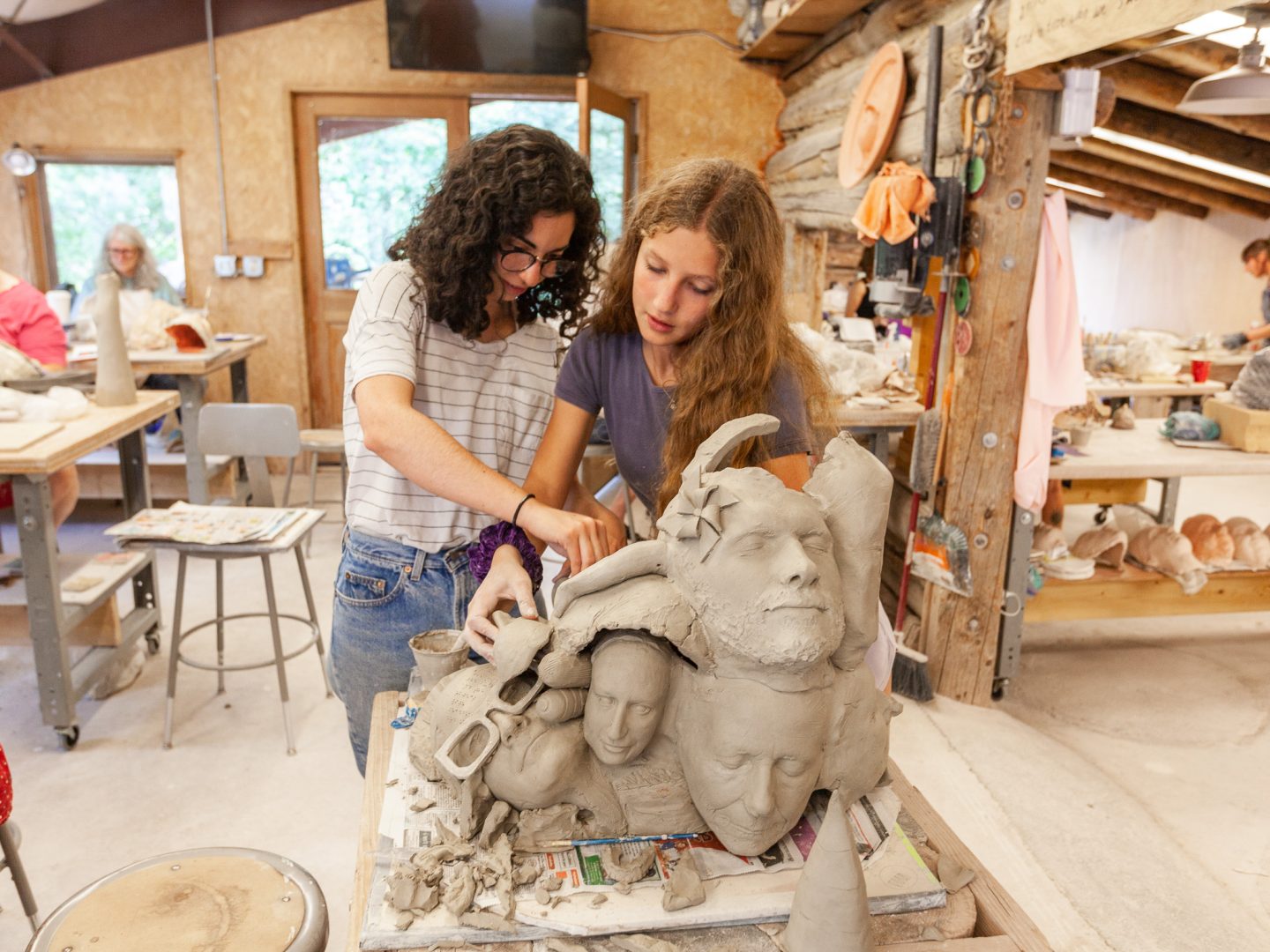 teen students creating hand-built clay projects in a ceramics studio