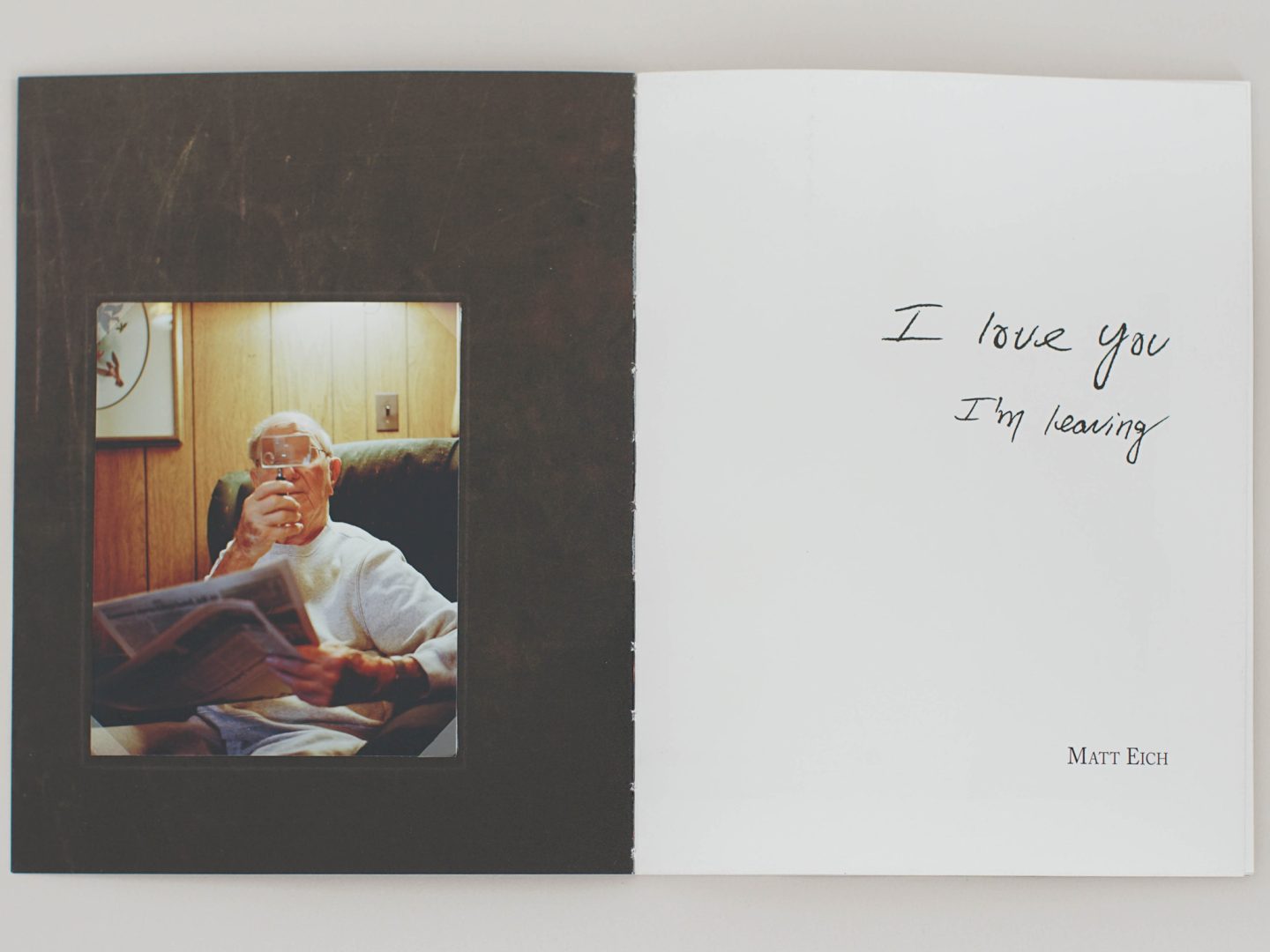 Photobook spread with an image of an older man using a magnifying glass and the text ‘I love you I am leaving,’ from a Printed Stories workshop.