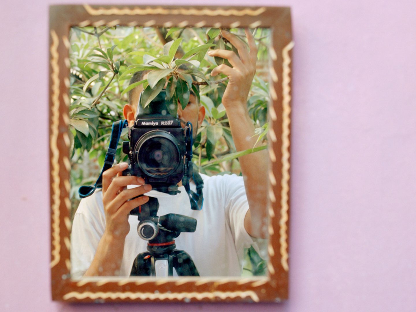 Person photographing their reflection in a mirror during a photography and new media workshop